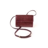 A vintage Gucci style shoulder bag, in maroon lizard skin, and with removable buckle strap for