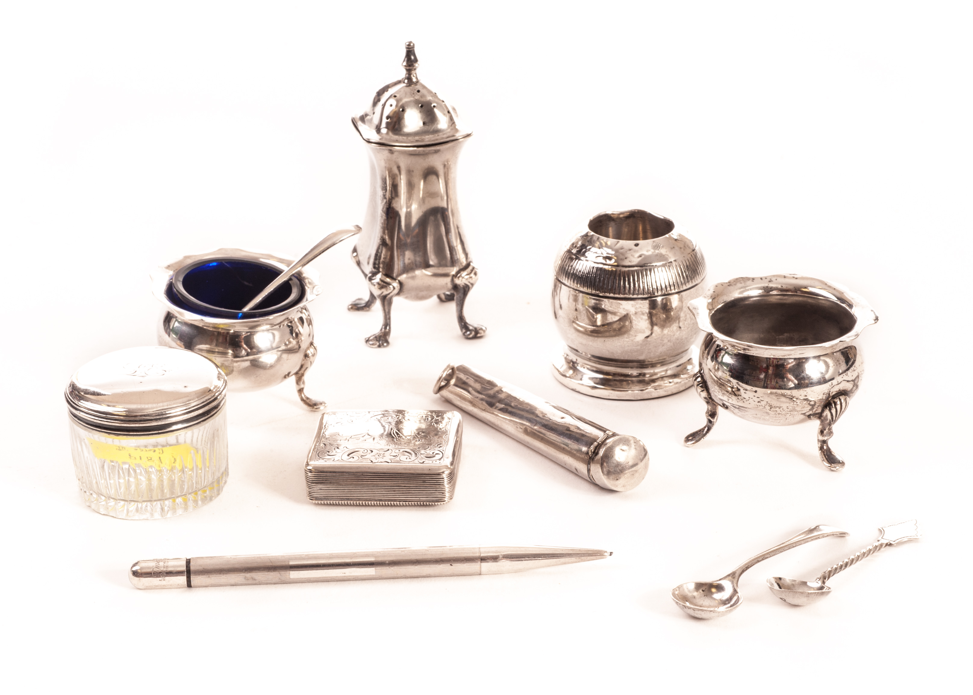 A small group of silver items, including as silver cased amber cheroot holder, a pair of salts by