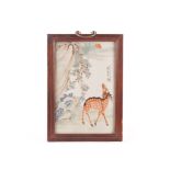 A Qing period early 20th century Chinese porcelain plaque, decorated with a deer beneath rock and