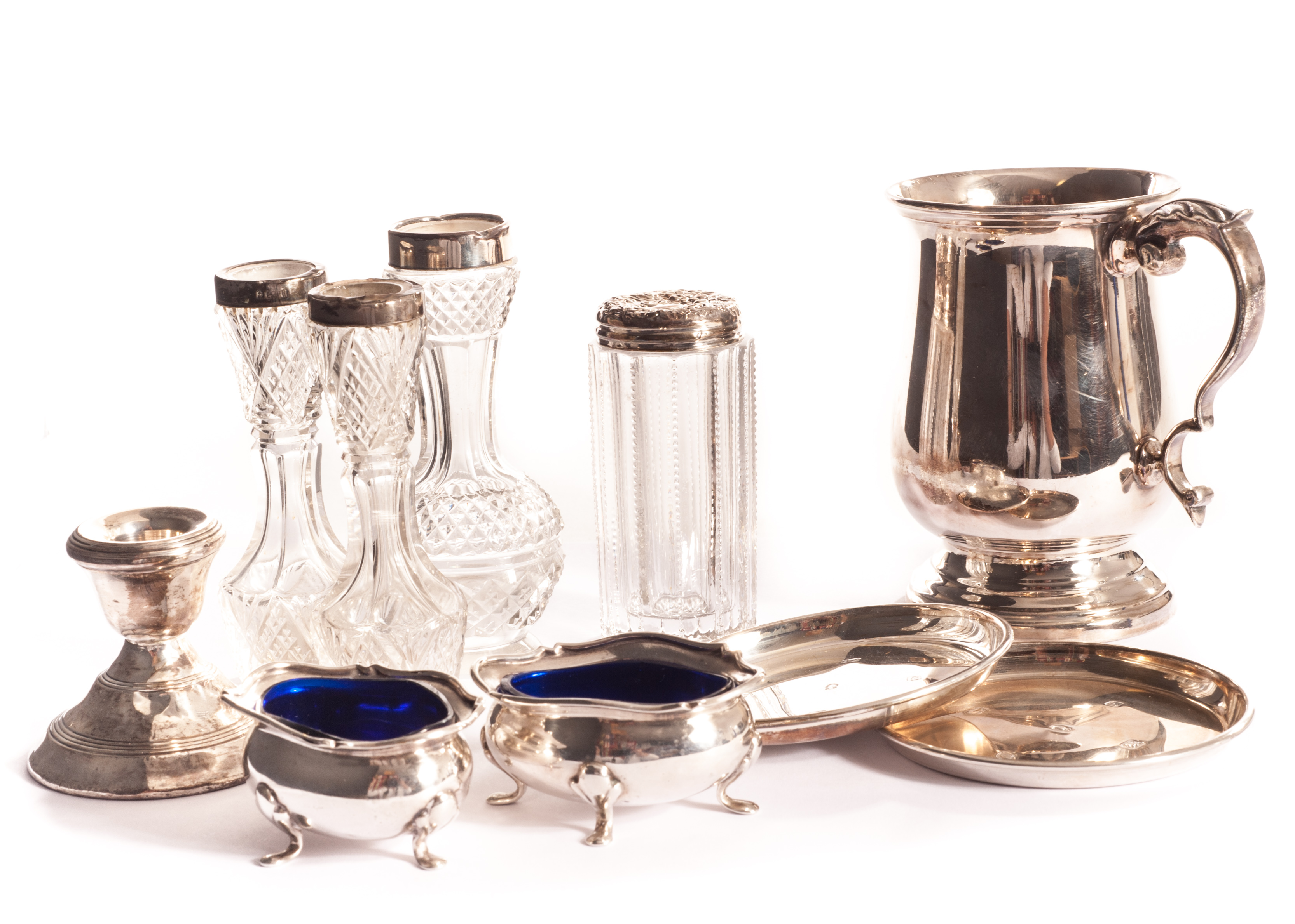 A collection of silverware, including a pair of silver serpentine cauldron salts, a silver