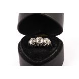 An early 20th century three stone diamond engagement ring, the three old cuts in claw settings (