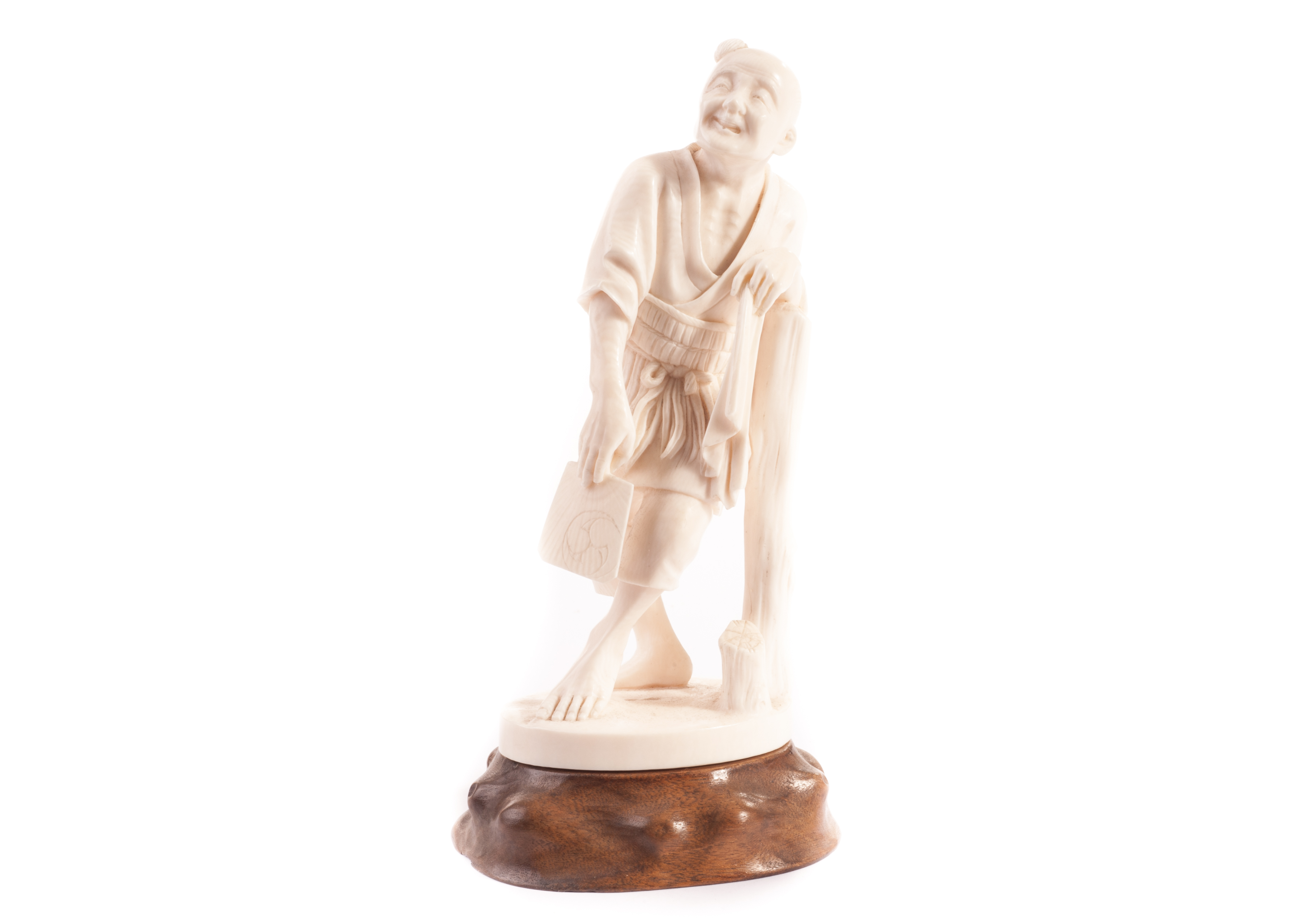 A Meiji period Tokyo school ivory Okimono, of an exhausted man with handkerchief and fan resting