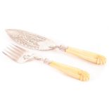 A pair of 19th century continental white metal and ivory fish servers, with ornate pierced and