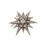 An impressive Edwardian period diamond brooch, the star shaped gold and silver mount set with old