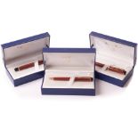 A modern trio Waterman pen set, the Liaison range in orange and black with black and gilt mounts,