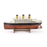 A Bing 3rd Series clockwork Tinplate Liner, with red and black hull, white decks, three funnels,