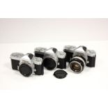 Nikkormat FT Cameras: three chrome bodies (one, the home market version) together with a case and