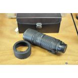 A Tokina AT-X AF f/4 100-300mm Lens, Nikon mount, in maker's case