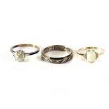 A 9ct white opal ring, plus two other  rings marked gold and silver (3)