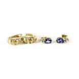 A pair of 9ct gold sapphire and diamond stud earrings,  the oval cut sapphire above three