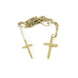 Two 9ct gold crosses, on two fine 9ct gold chains, approx 10.6g