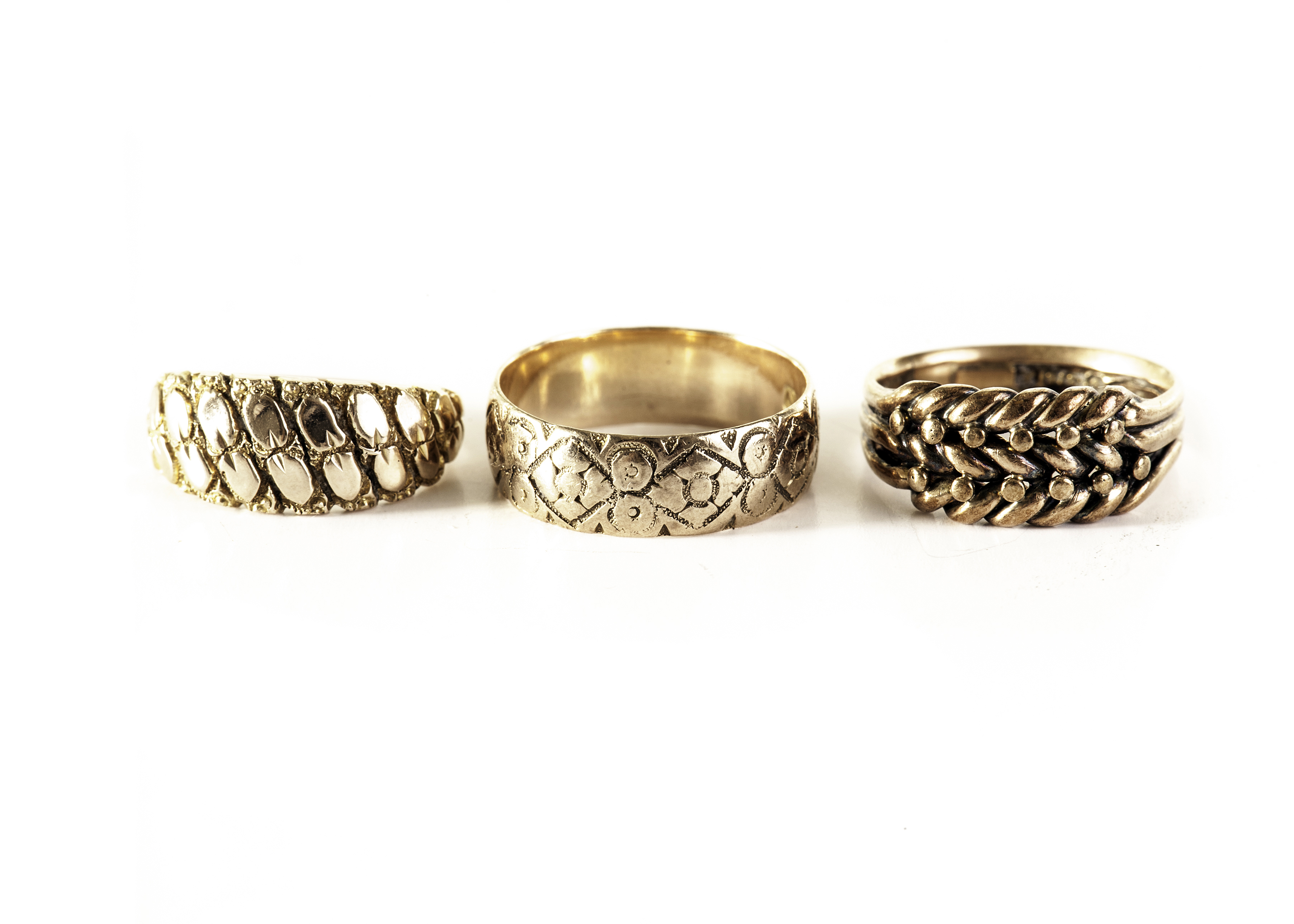 Three 9ct gold rings, each having different engraved or pierced design, approx 11.8g