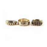 Three 9ct gold rings, each having different engraved or pierced design, approx 11.8g