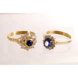 Two yellow metal and gem set cluster rings, both marked 750, with a central blue stone surrounded by