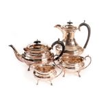 A George V silver four piece tea service, comprising teapot, hot water jug, sugar basin and milk jug