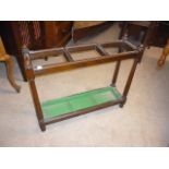 A Victorian oak umbrella hall stand, three sections to upper, with four supports, and a green