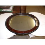 An Edwardian oval mirror, having varnished mahogany surround, approx 61cm H