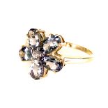 A 9ct gold and gem set dress ring, having flower head design, with centre round cut clear stone,