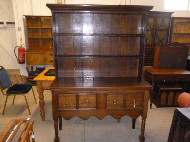 A 19th century and later oak dresser, having possibly 18th century upper plate rack section, with