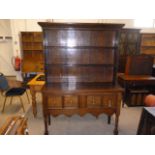 A 19th century and later oak dresser, having possibly 18th century upper plate rack section, with