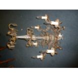 A lead crystal and brass chandelier, having twist glass style body, floral glass pendants and