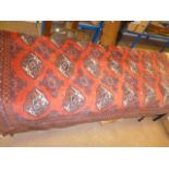 A red ground hand knotted Eastern carpet, having multi-medallion central design, with multi-borders,