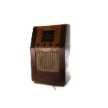 A large vintage Bush Radio, the A.C Receiver Type S.U.G 26, with four control knobs to front, approx