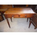 Victorian mahogany writing table, with two drawers over turned tapering legs