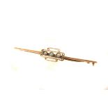 A 9ct gold opal three stone bar brooch, the three stones set in a scroll style design, in 9ct gold