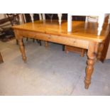 A pine kitchen table, on turned legs, approx 151cm L