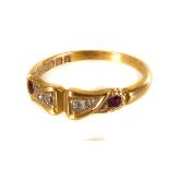 An 18ct gold diamond and ruby ring, having four graduated round cut diamonds flanked by two