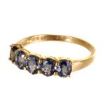 A 9ct gold five stone dress ring, the five oval cut stones of either tourmaline or bi-colour