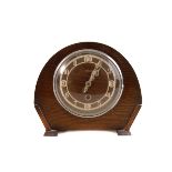 A small collection of various clocks, including a wall clock, two mantle clocks, a carriage clock