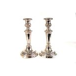 A pair of Sheffield plate candlesticks, with filled bases, re-plated