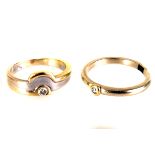 Two yellow metal solitaire rings, one having a brilliant cut in rubbed over mount, the other in a