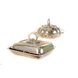 A graduated set of three silver plated chafing dishes and lids, together with a shaped example, plus