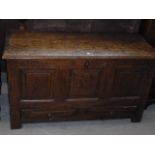 A late 18th/ early 19th century oak mule chest, having planked top, above three panels and two