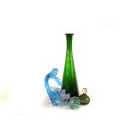 A selection of various glass items, including a green chemists' bottle, a decanter and stopper, a