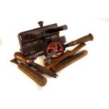 A collection of wooden cabinet makers tools, including chisels, planes, a hand drill and more (