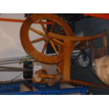 A modern beech spinning wheel, together with a selection of various accessories