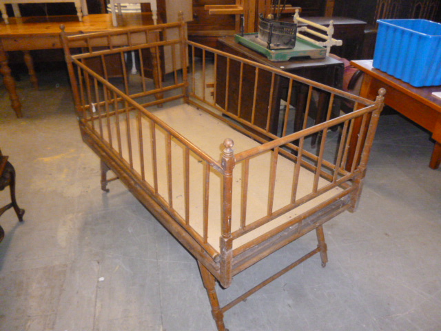 An Edwardian cot, having fold down sides, approx 143cm L