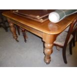 A Victorian mahogany extending dining table, with two later leaves, and supported on baluster