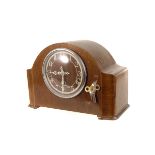 An Enfield domed walnut veneered mantle clock, with white Arabic numerals to face