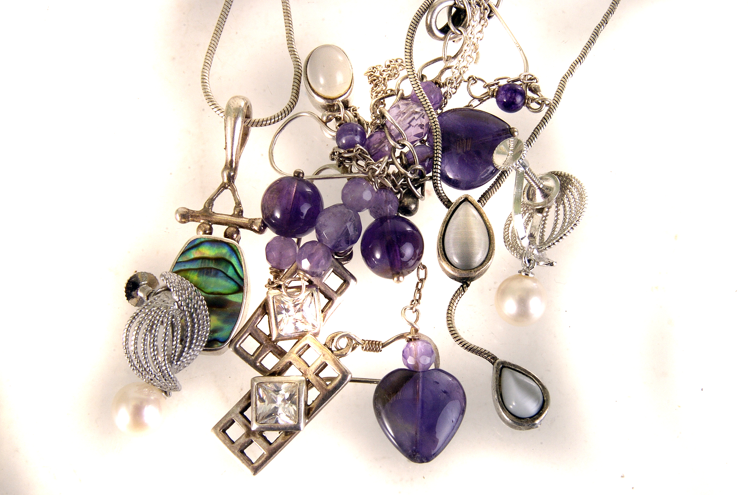 Six items of jewellery, including a pair of amethyst drop pendant earrings, a silver and mop