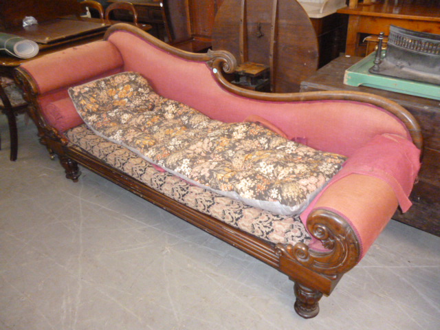A William IV mahogany chaise long, with shaped scrolling back and arms, supported on turned lappet