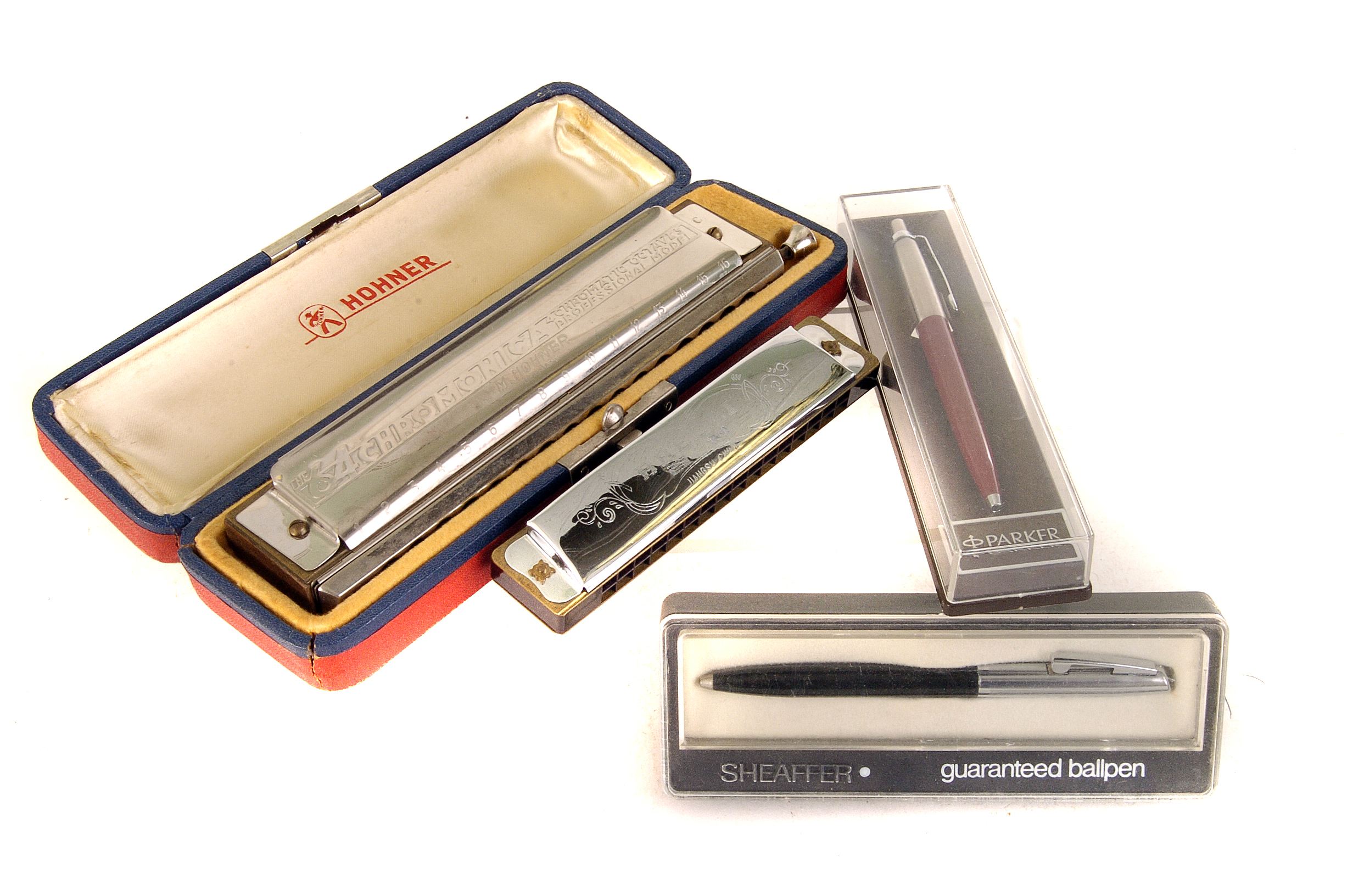 A small selection of various Harmonicas, including Hohner, together with a group of five pens, to