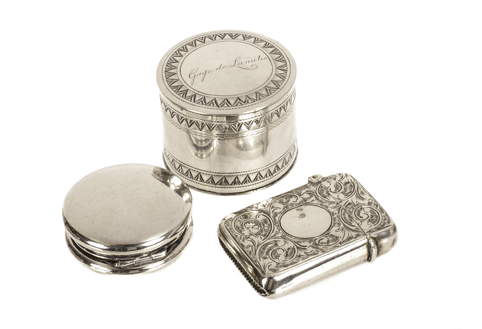 Three small silver items, including an interesting small French circular box marked “Gage de