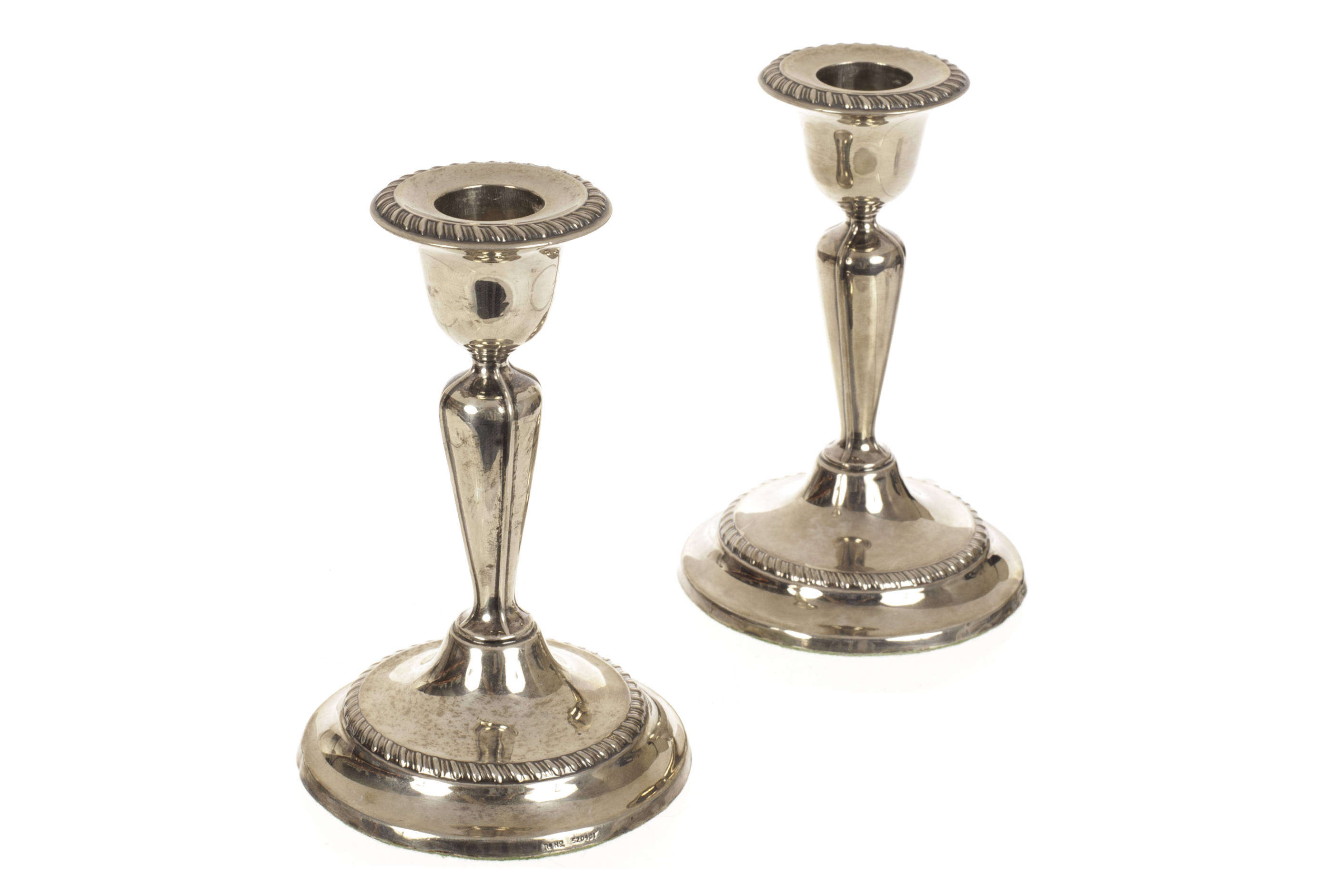 A pair of silver dwarf candlesticks, hallmarked Sheffield 1912, by Fordham & Faulkner, with loaded