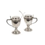 A pair of fine George III silver vase shaped mustard pots, the conical wells on spreading foot