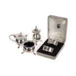 A George V silver cruet set, marks for Chester and Birmingham 1911, plus a boxed pair of silver